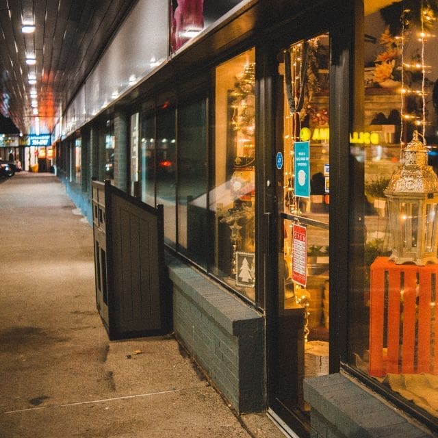 a storefront with lights on the windows