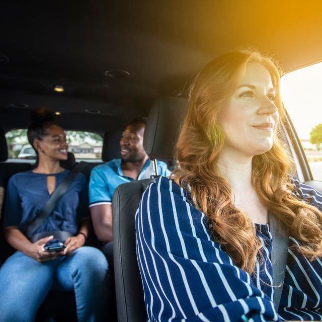 woman driving with three passengers